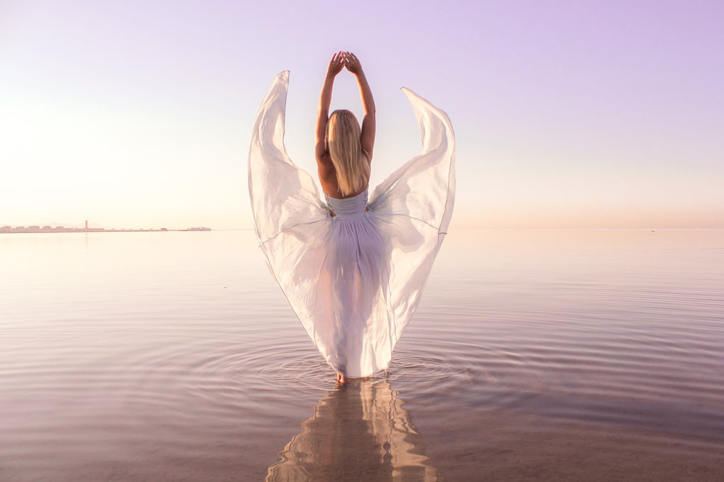 Woman in White Dress Standing in Body of Water